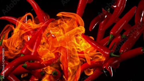 Super Slow Motion Shot of Red Chilli Peppers and fire at 1000fps. Shooted with High Speed Cinema at 4K. photo