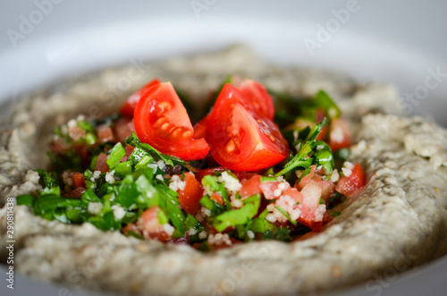 lebanese hummus dish with fresh vegetables, beef meat & pomegranate seeds