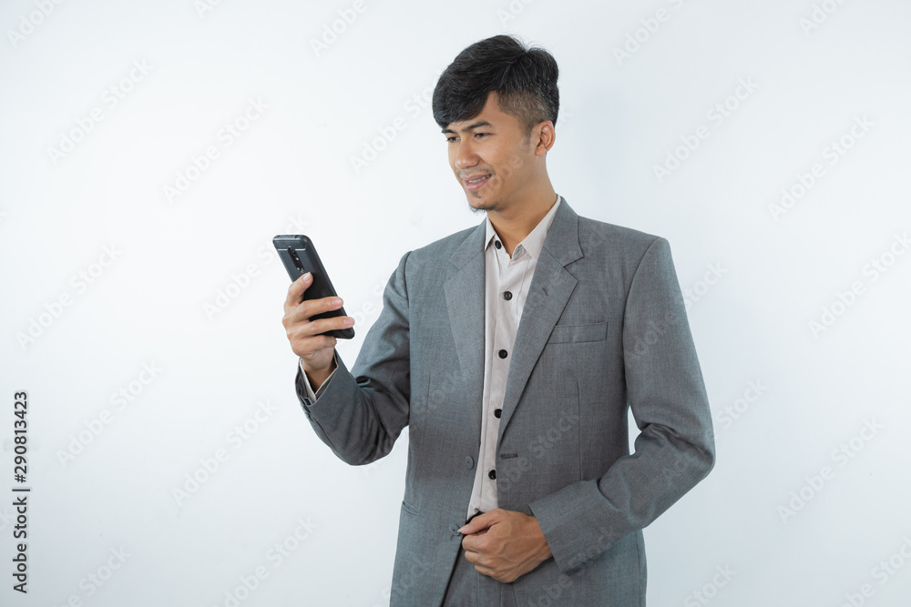 Portrait of asian young business man using smart cell phone isolated on white background. Portrait of asian young business man using smart cell phone isolated on white background.