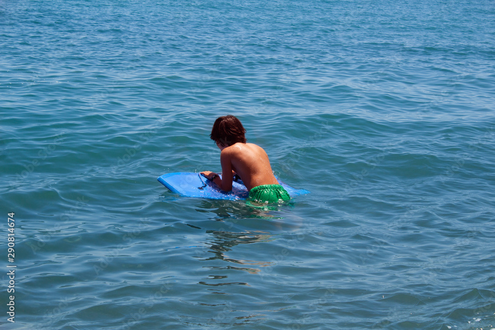 Boy on a blue sea.