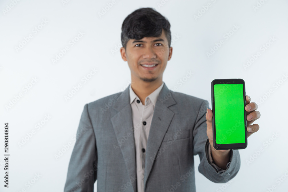 Portrait of Asian Young Business man showing smart cell phone with green screen phone isolated on white background. Portrait of Asian Young Business man showing smart cell phone with green screen phone isolated on white background.
