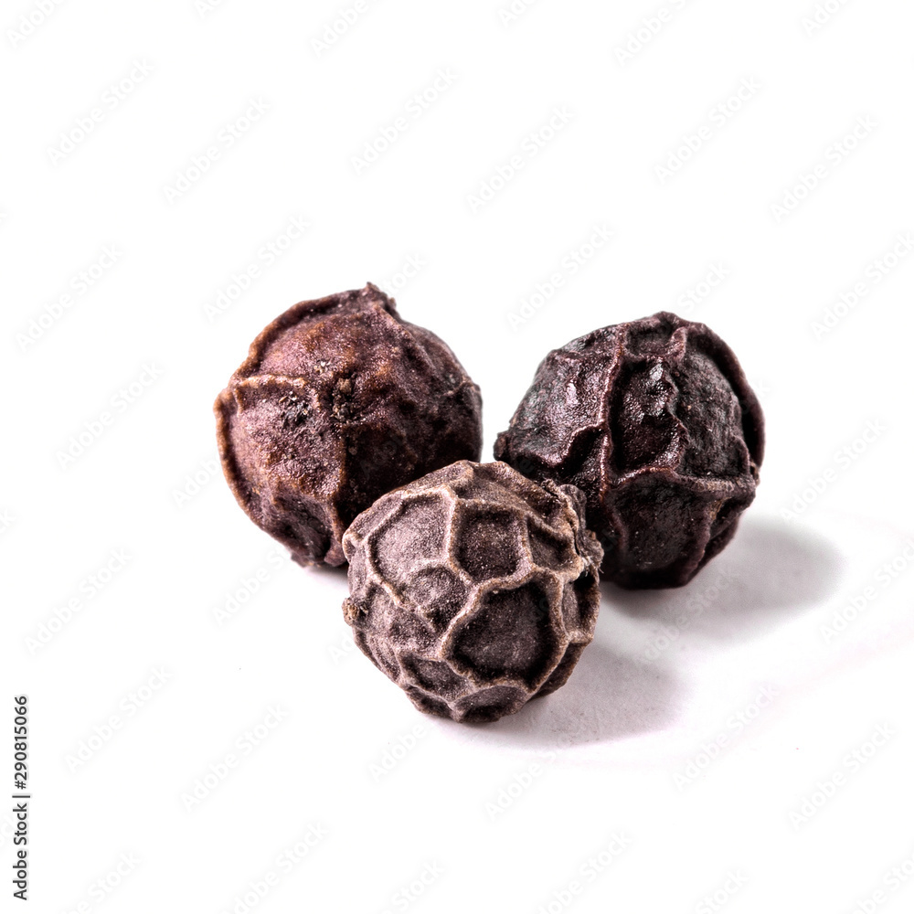 three balls of black pepper on a white background isolated close-up three balls of black pepper on a white background isolated close-up