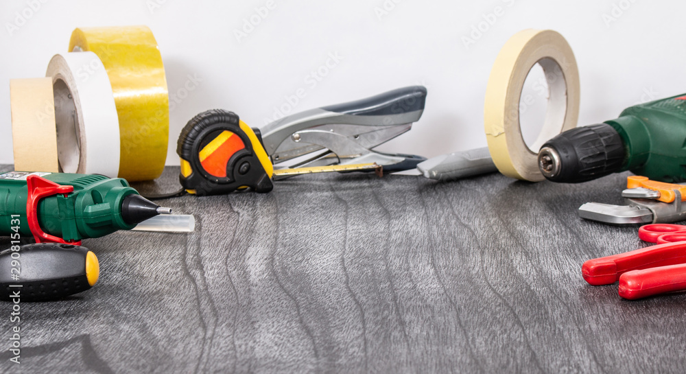 Do it yourself tools on grey wooden background. DIY tools with copy space for text on black background. Different tools for handwork & handmade concept. Repair & creating theme. Do it yourself tools on grey wooden background. DIY tools with copy space for text on black background. Different tools for handwork & handmade concept. Repair & creating theme.