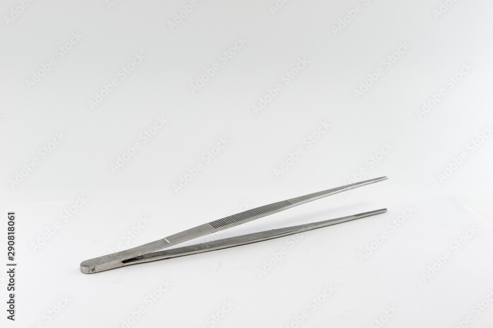 Old stainless steel tweezers. Isolate on a white background. Old stainless steel tweezers. Isolate on a white background.