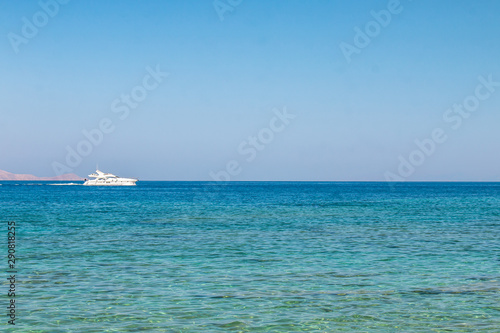 Boat sailing far at the open sea. Yacht at sea. Luxury summer adventure, active vacation in Mediterranean sea. © Artem