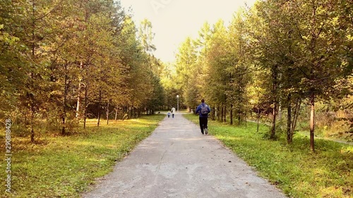 Wallpaper Mural Man with Backpack Running on Road in Autumn Forest. Jogging in Nature. Cardio Workout Outdoors Torontodigital.ca
