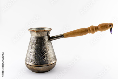 Copper cezve with wooden handle on a white background