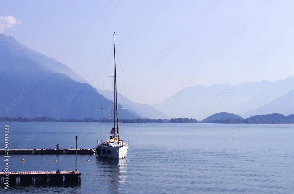 sailing boat lying at a pier on a lake