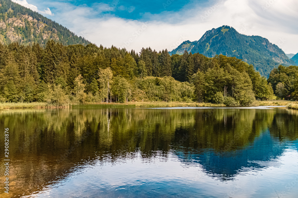 Beautiful alpine view with a lake with mountain reflections at Oberstdorf, Bavaria, Germany