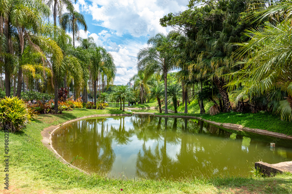 Lake in a public outdoor park surrounded by green trees and exercise toys in Jundiai, Sao Paulo, Brazil