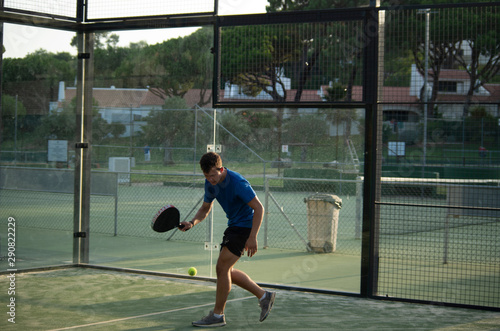 Padel player glass walls tennis squash hybrid evening portugal © Luke