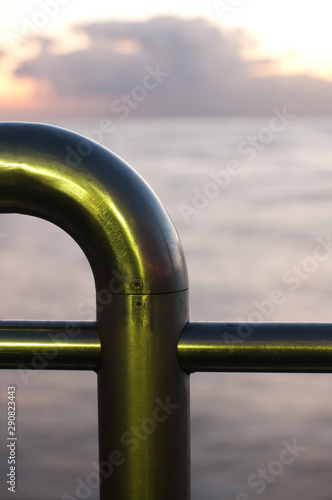Metal railing by the beach in tuscany,