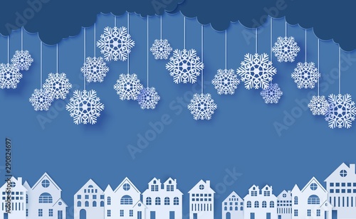 Snowflakes on ropes hanging over houses in paper cut style. Clouds in blue night sky and city buildings. Vector papercut winter concept. Merry Christmas sale banner template, creative promotion card.