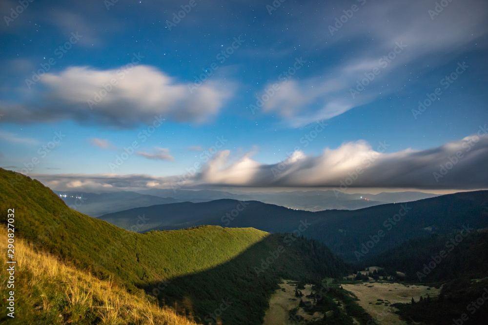 Fototapeta premium Panorama of the starry sky over the foggy mountains