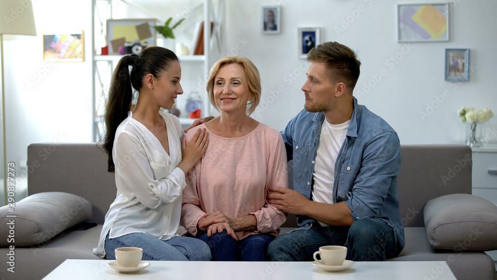 Couple embracing mother-in-law, relationship of trust and love, understanding Couple embracing mother-in-law, relationship of trust and love, understanding