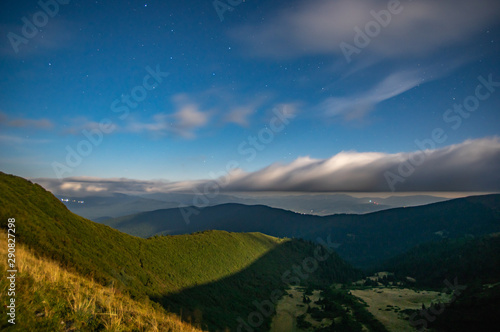 Panorama of the starry sky over the foggy mountains