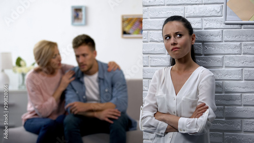 Desperate wife secretly listening husband with mother discussing relations