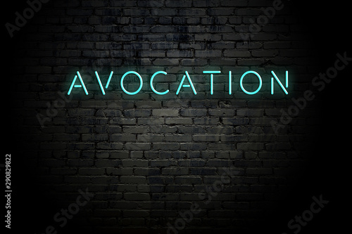 Fotografi Highlighted brick wall with neon inscription avocation