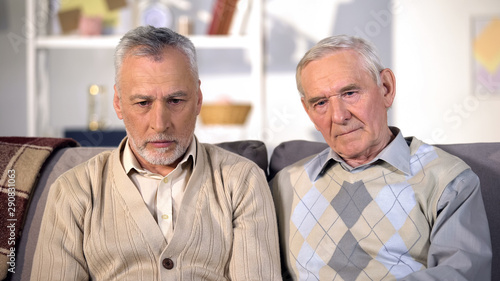 Two desperate old men looking thoughtful, problem depression, old age crisis