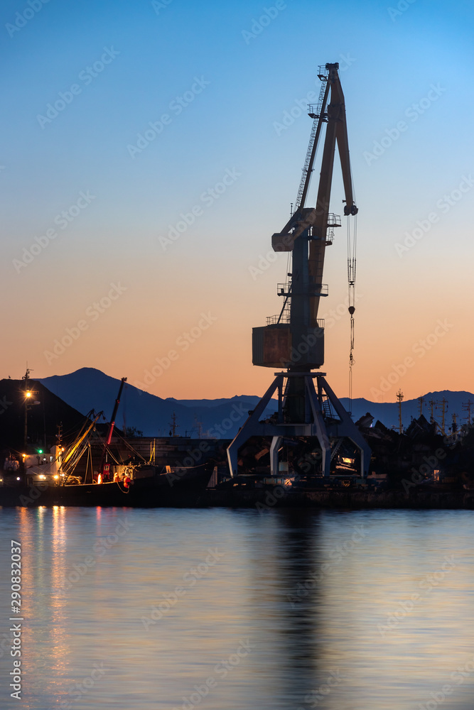 A shipping crane in the Port of Petropavlovsk, Russia at sunset.