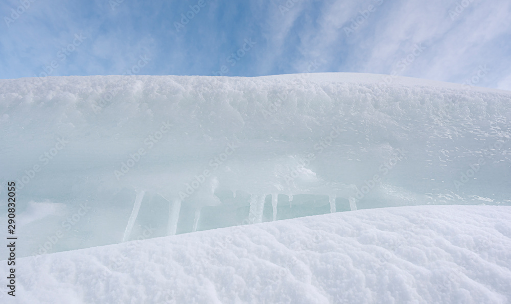 Fototapeta premium White clean snowdrifts and icicles close-up. Pile of snow