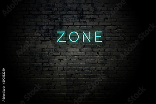 Highlighted brick wall with neon inscription zone