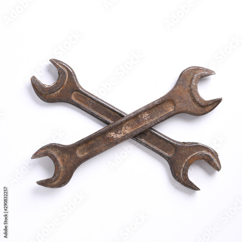 Old rusty stainless steel crescent wrench isolated on white top view