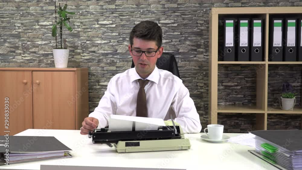 secretary is typing at a table with a cup of coffee in the workplace