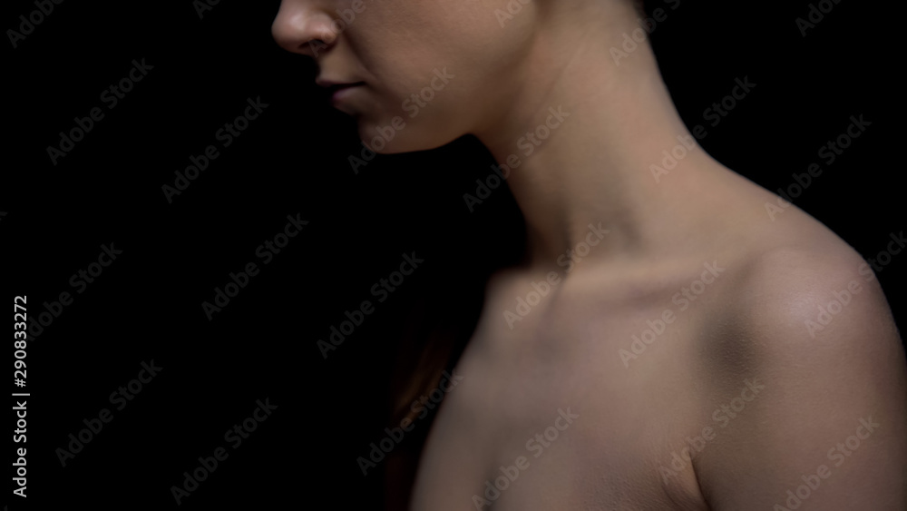 Naked female standing against black background, harassment victim, kidnapping Naked female standing against black background, harassment victim, kidnapping