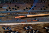 Indian incense stick on a wooden stand closeup