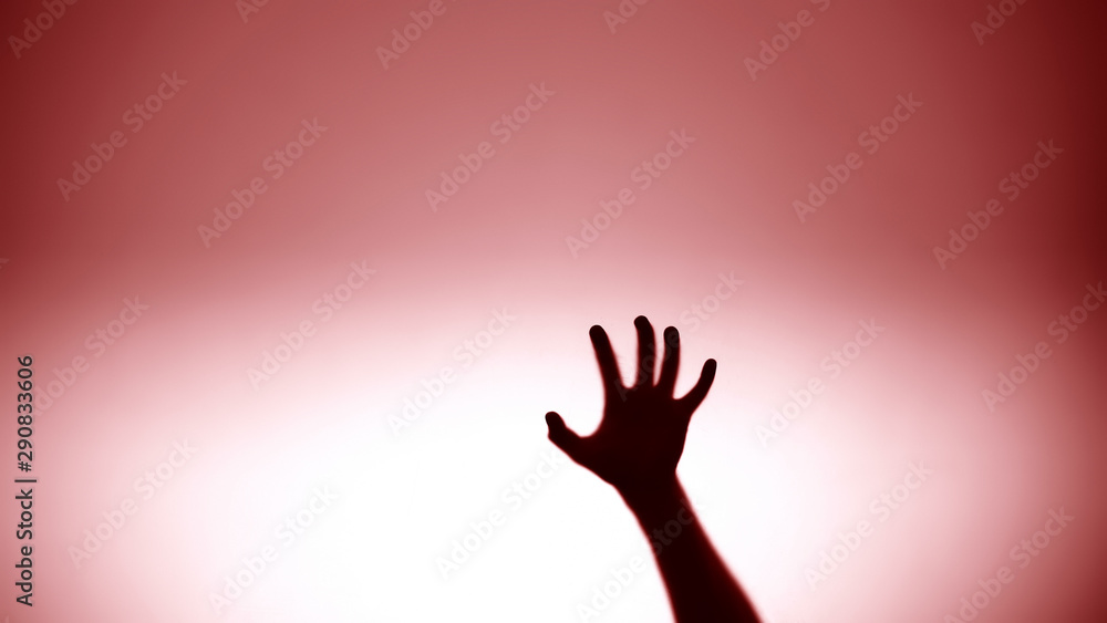 Hand sliding down on glass, red flashlight on background, crime scene, murder
