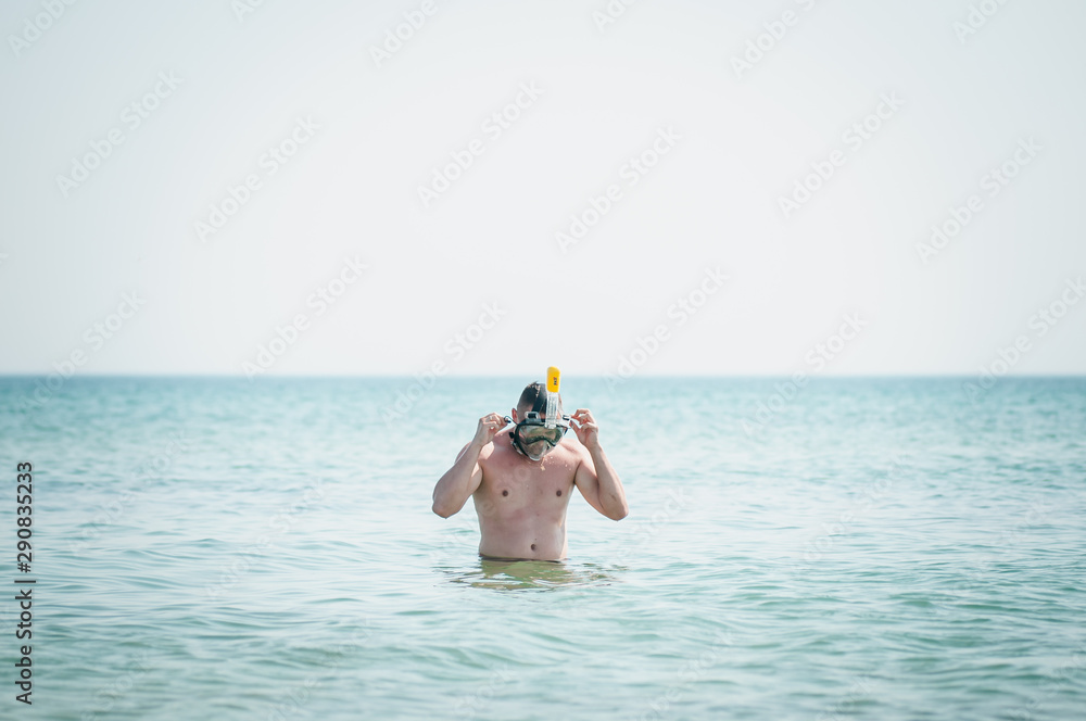 Man in swiming mask going on water