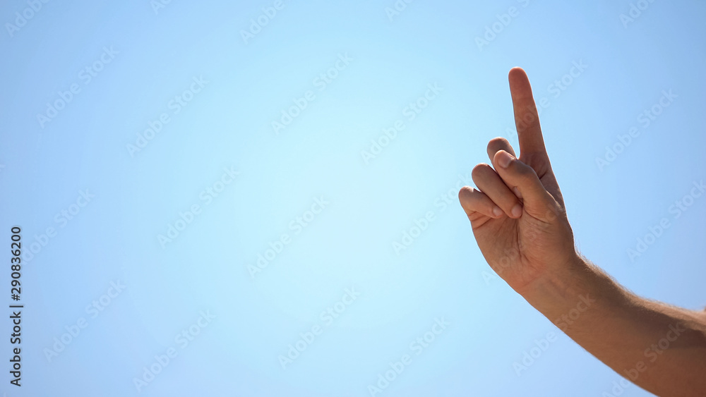 Male hand pointing finger up on sky background, concept of new idea, wise advice - obrazy, fototapety, plakaty 