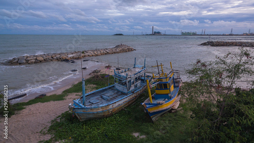 aerial view the two old fishing boats on Suchada beach close the power plant