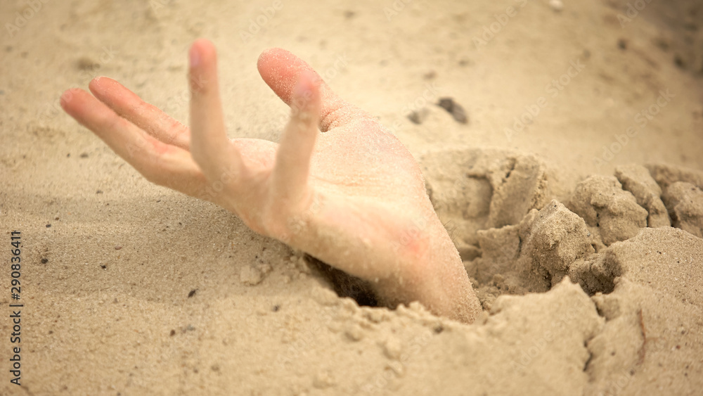 Male hand sinking in puddle of quicksand, dangerous travels in desert,  closeup Stock Photo | Adobe Stock