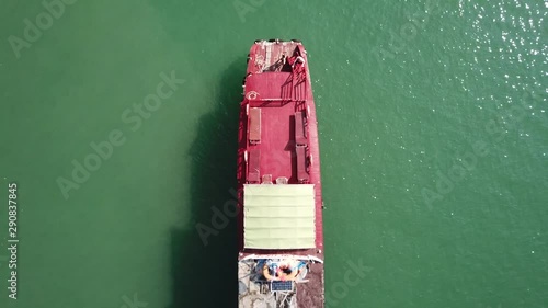 Aerial overhead shot over a red ferry in the Ha Long bay in Vietnam. photo