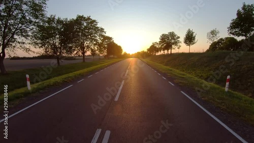 On a rural road to sunset, pov
