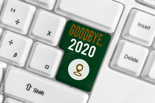 Word writing text Goodbye 2020. Business photo showcasing New Year Eve Milestone Last Month Celebration Transition White pc keyboard with empty note paper above white background key copy space photo