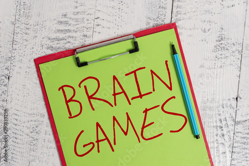 Handwriting text Brain Games. Conceptual photo psychological tactic to analysisipulate or intimidate with opponent Colored clipboard blank paper sheet marker old wooden vintage background photo