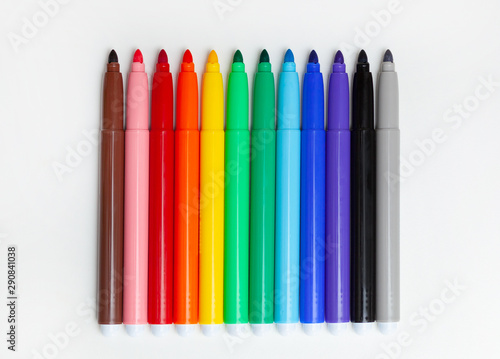 Multi-colored felt-tip pens, markers on white.