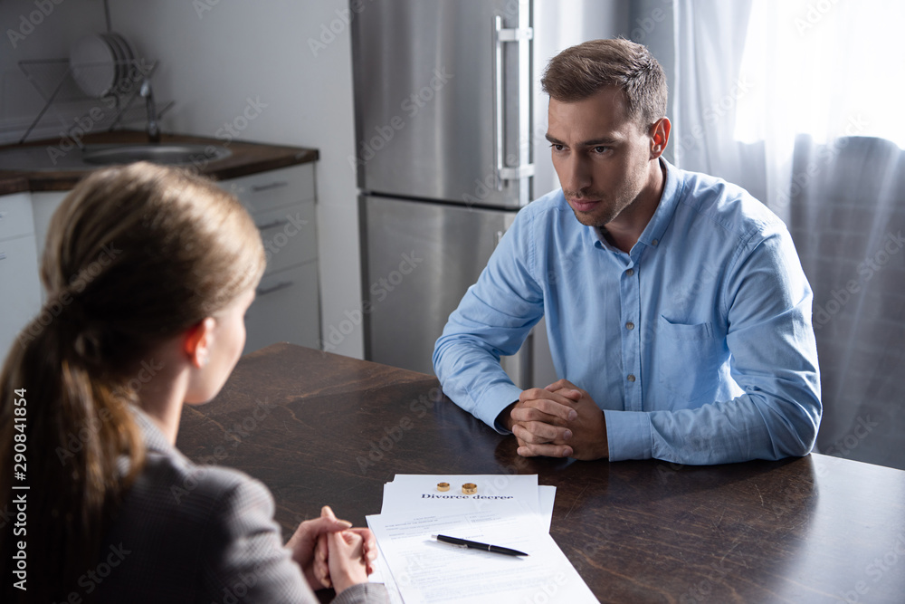 Fototapeta premium couple with divorce documents at table at home