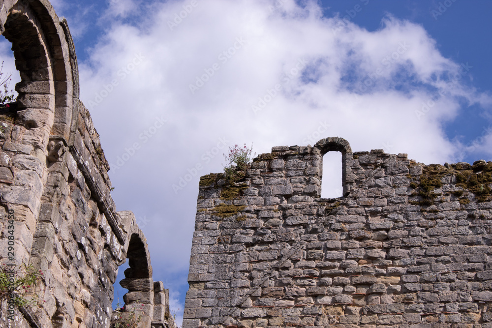 Ancient ruins with wall, arches and window