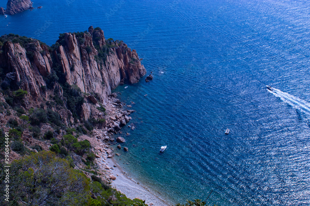 Tranquil bay with cliff and motorboat