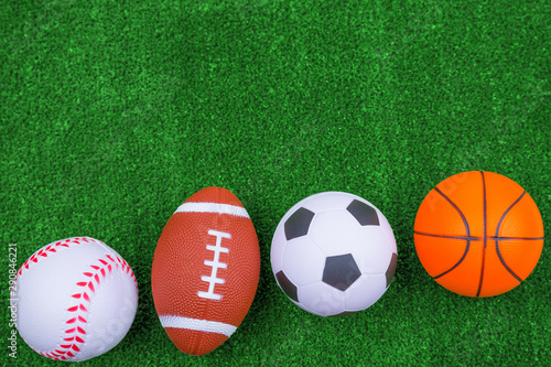 Balls for baseball, american football, basketball, soccer. lie on the green. Outdoor sports championship. Different types of games. copy space
