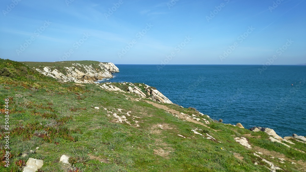 rock clifs by the ocean blue skyline peniche portugal