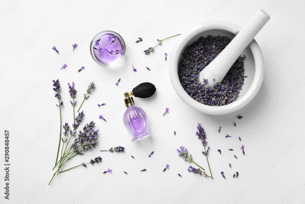 Fototapeta Composition with natural perfume and lavender flowers on white background, top view. Cosmetic product