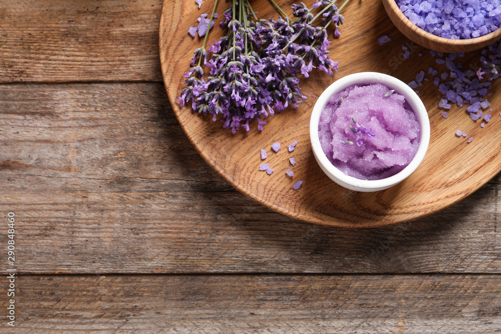 Plate with natural cosmetic products and lavender flowers on wooden table, top view. Space for text Plate with natural cosmetic products and lavender flowers on wooden table, top view. Space for text