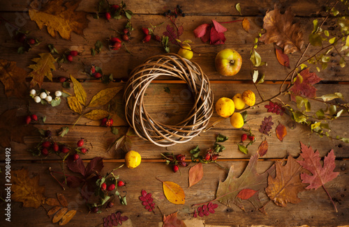 Autumn composition with Wreath,dry leaves gifts and berries/making autumn wreath