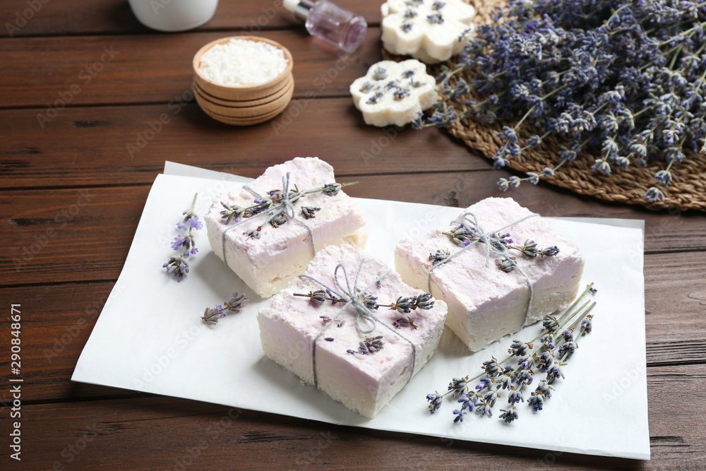 Hand made soap bars with lavender flowers on wooden table Hand made soap bars with lavender flowers on wooden table