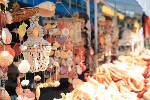 Wind chimes made of sea shells in outdoor souvenir shop. Space for text